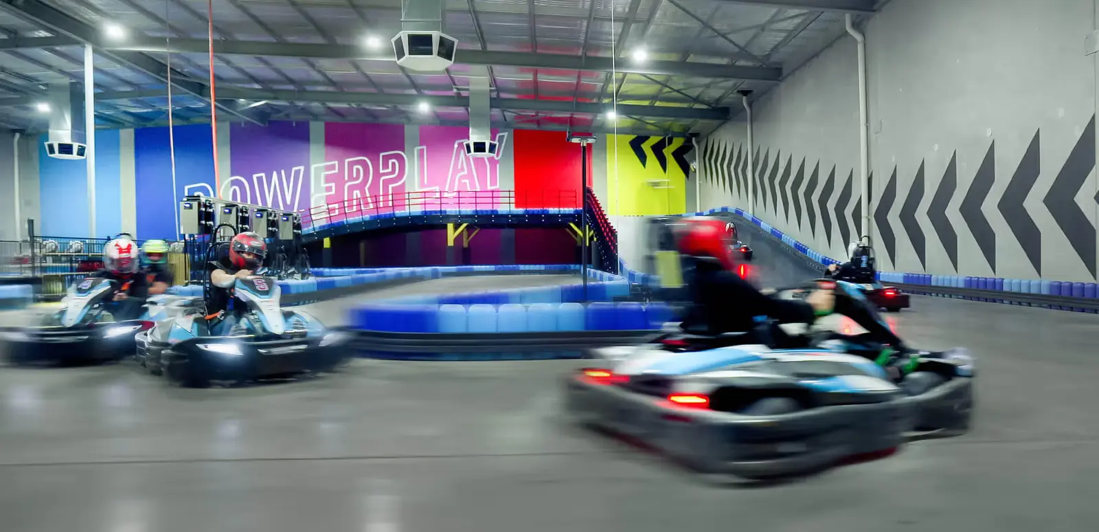 Electric karts racing on a PowerPlay track